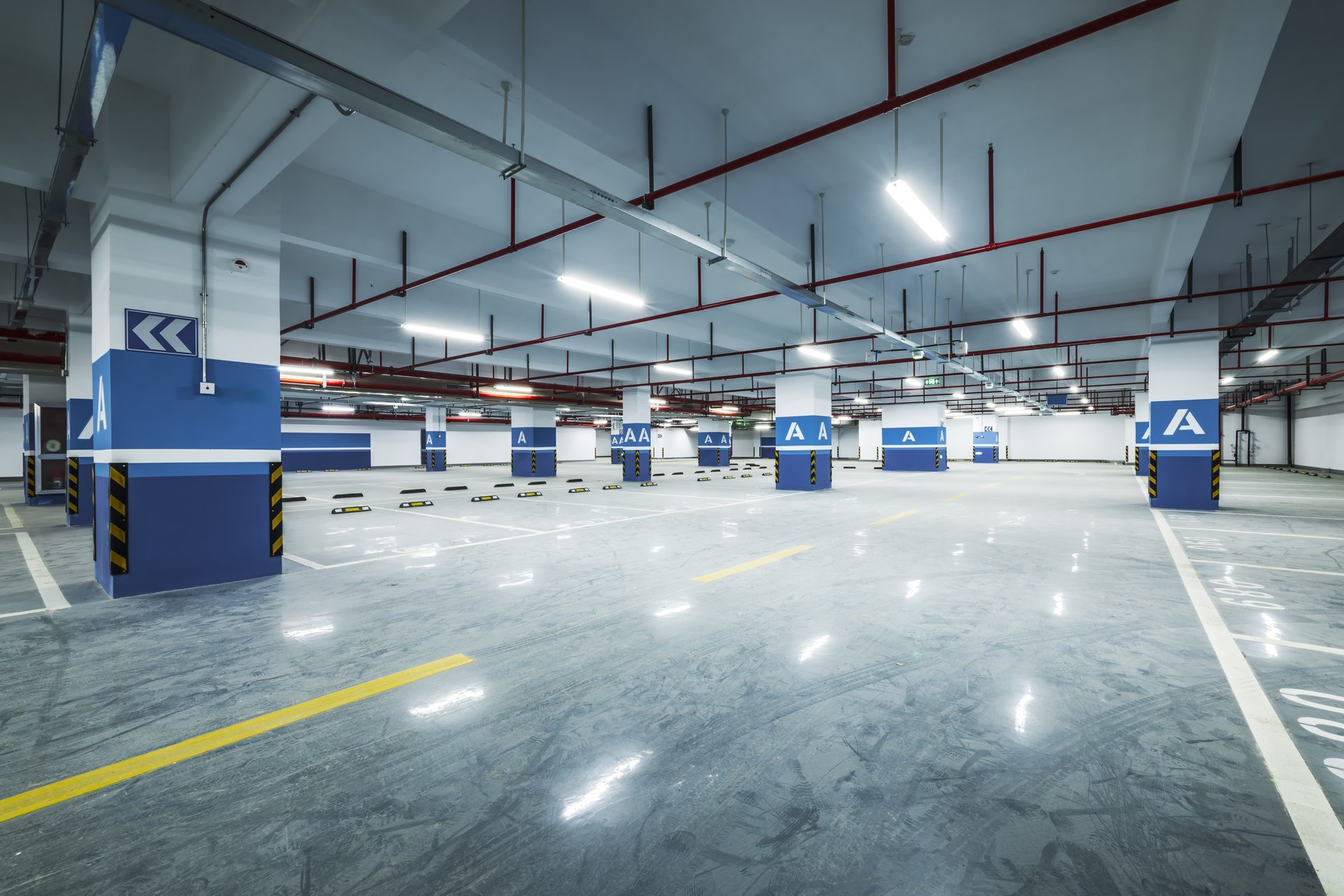 Modern underground parking garage with bright uniform lighting