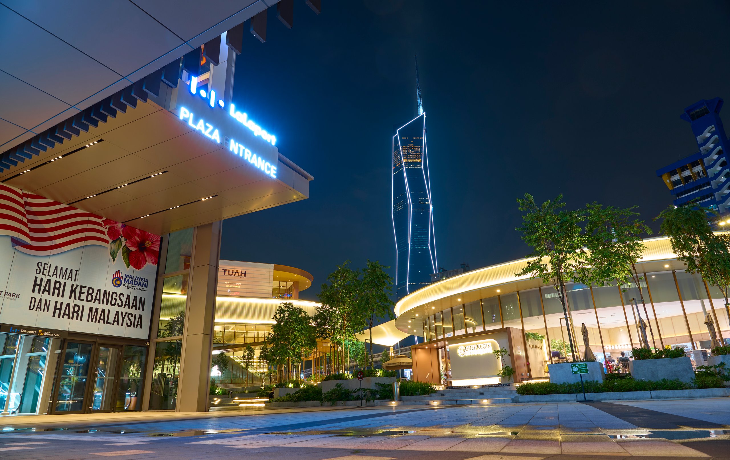Modern shopping mall plaza illuminated at night