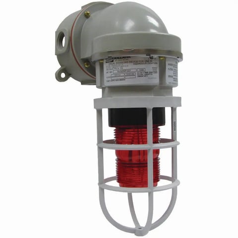 Industrial strobe warning light with gray dome cap, red flash tube, and protective metal cage